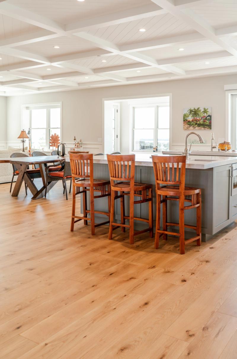 Kitchen island with bar seating on wide-plank engineered hardwood floor