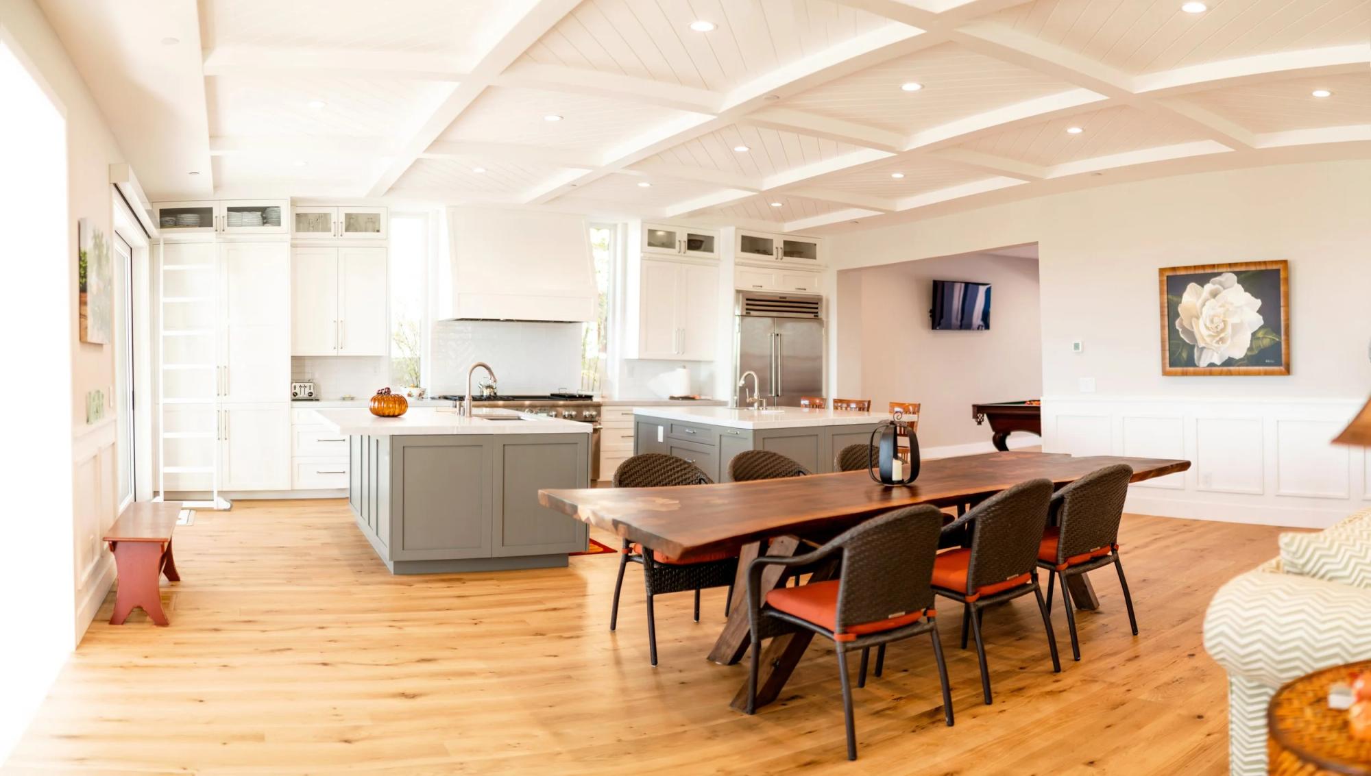 Panoramic view of open-concept kitchen and dining with wide-plank hardwood flooring
