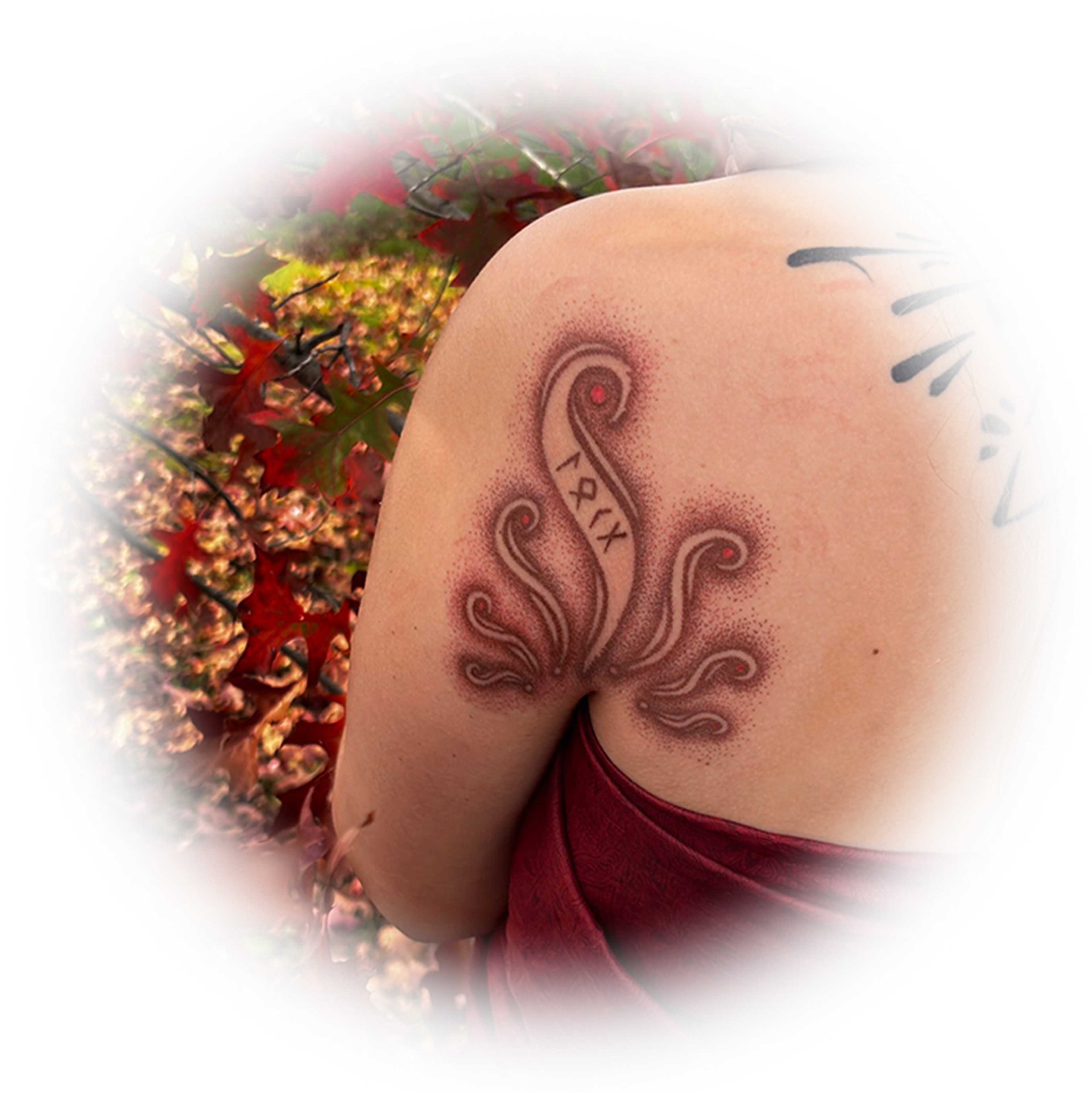 Hand-poked tattoo of a flowing ornamental design on a shoulder