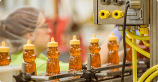 packaged busy bee bottles going through production