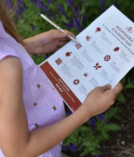 A kid holds a "BEESPONSIBLE SCAVENGER HUNT" sheet.