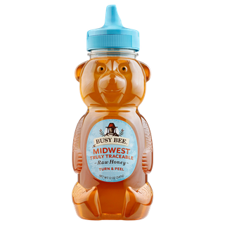 Front of 12 oz Midwest Busy Bee Raw Honey bear bottle with blue label and blue lid