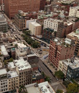 An aerial view of a dense urban environment with numerous buildings and streets.
