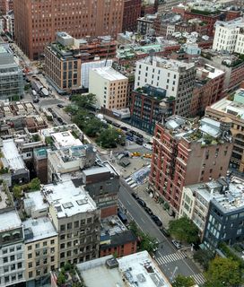 An aerial view of a dense urban environment with numerous buildings and streets.