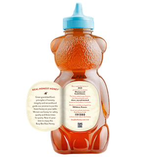 Back of 24 oz USA Busy Bee Raw Honey bear bottle with label peeled away to show this honey's story