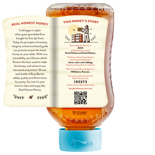 Back of 16 oz USA Busy Bee Raw Honey inverted bottle with label peeled away to show this honey's story