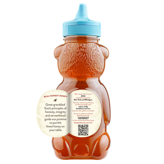 Back of 12 oz Great Lakes Busy Bee Raw Honey bear bottle with label peeled away to show this honey's story
