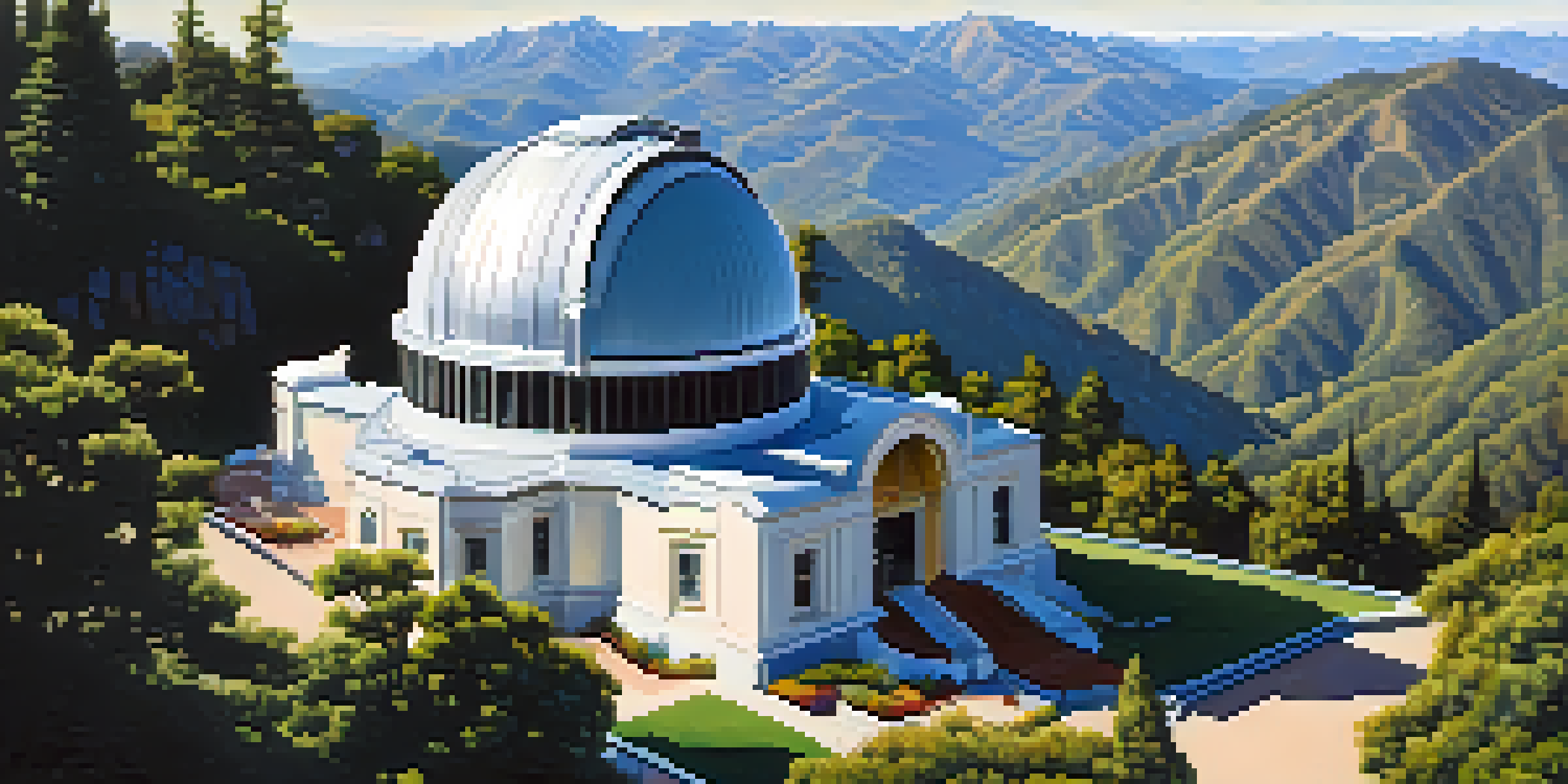 A wide view of Mount Wilson Observatory with large telescopes and surrounding mountains under a clear blue sky.