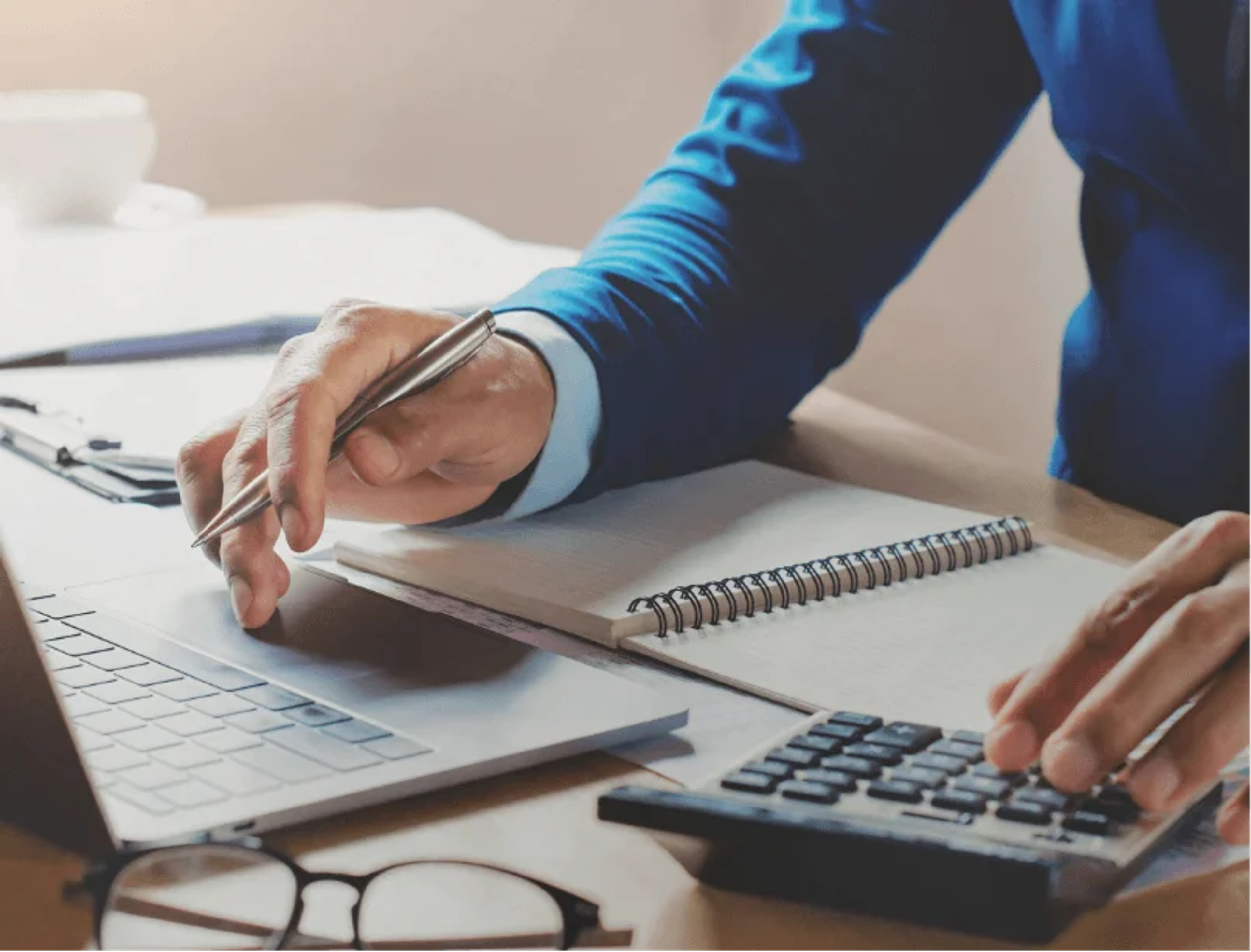 Person using a laptop and calculator