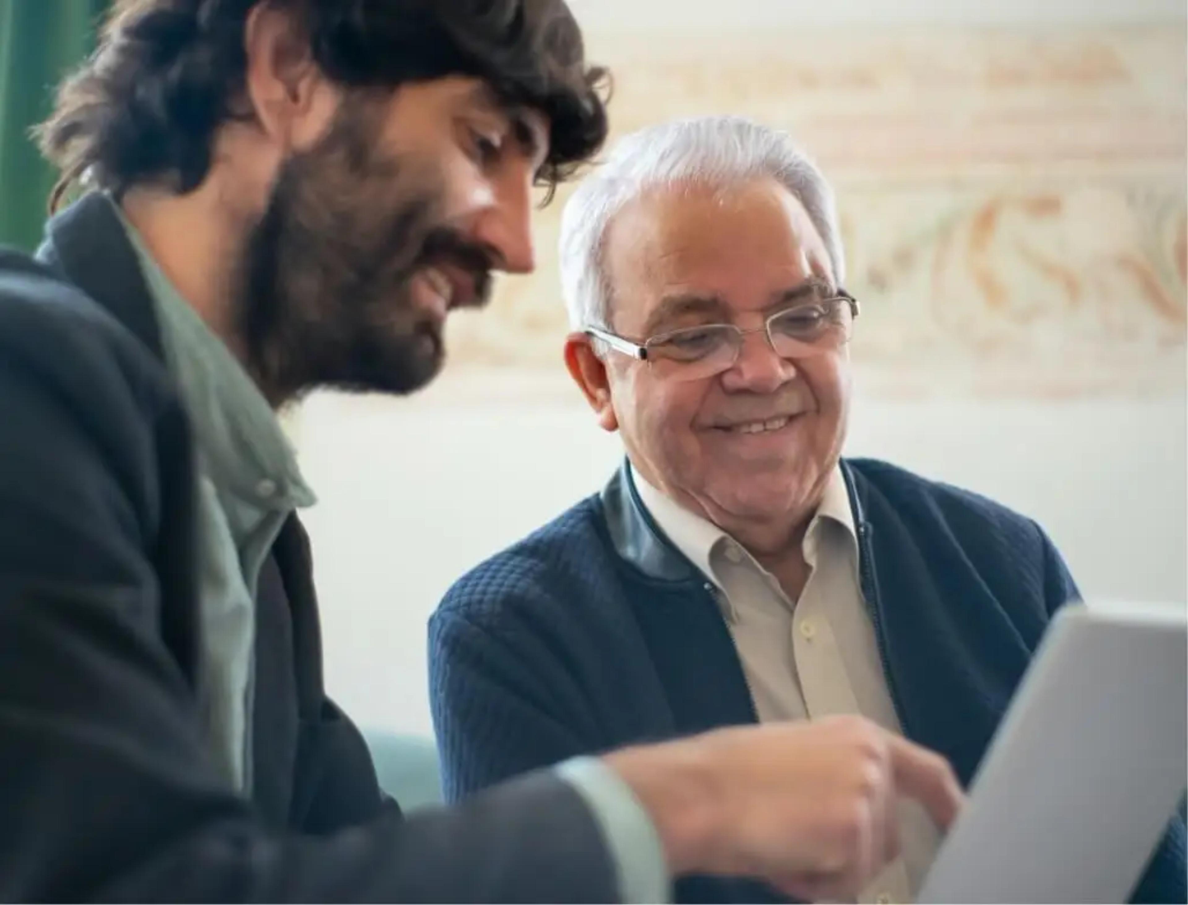 Two people discussing a document