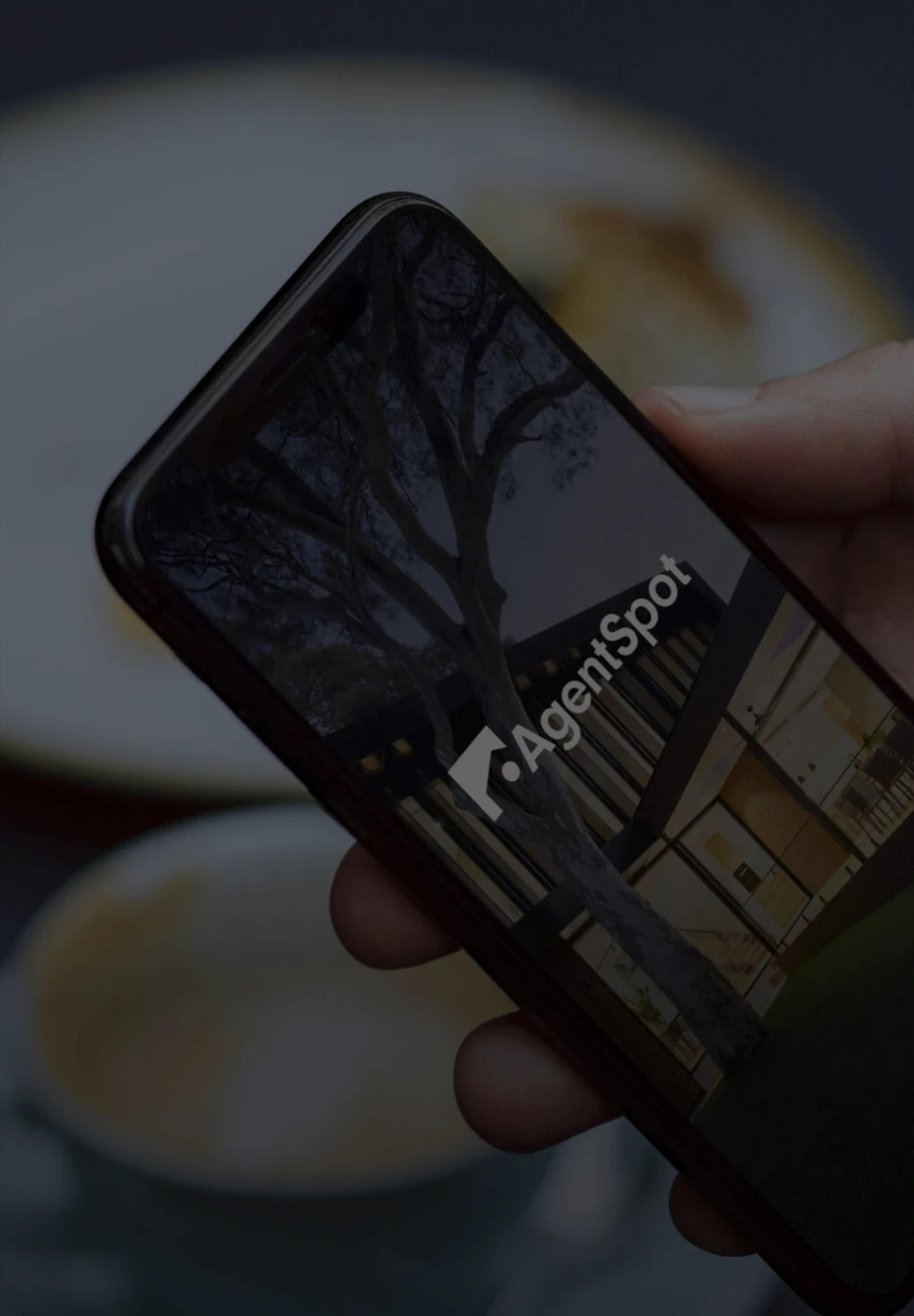 Phone with the agent spot logo displayed on its screen