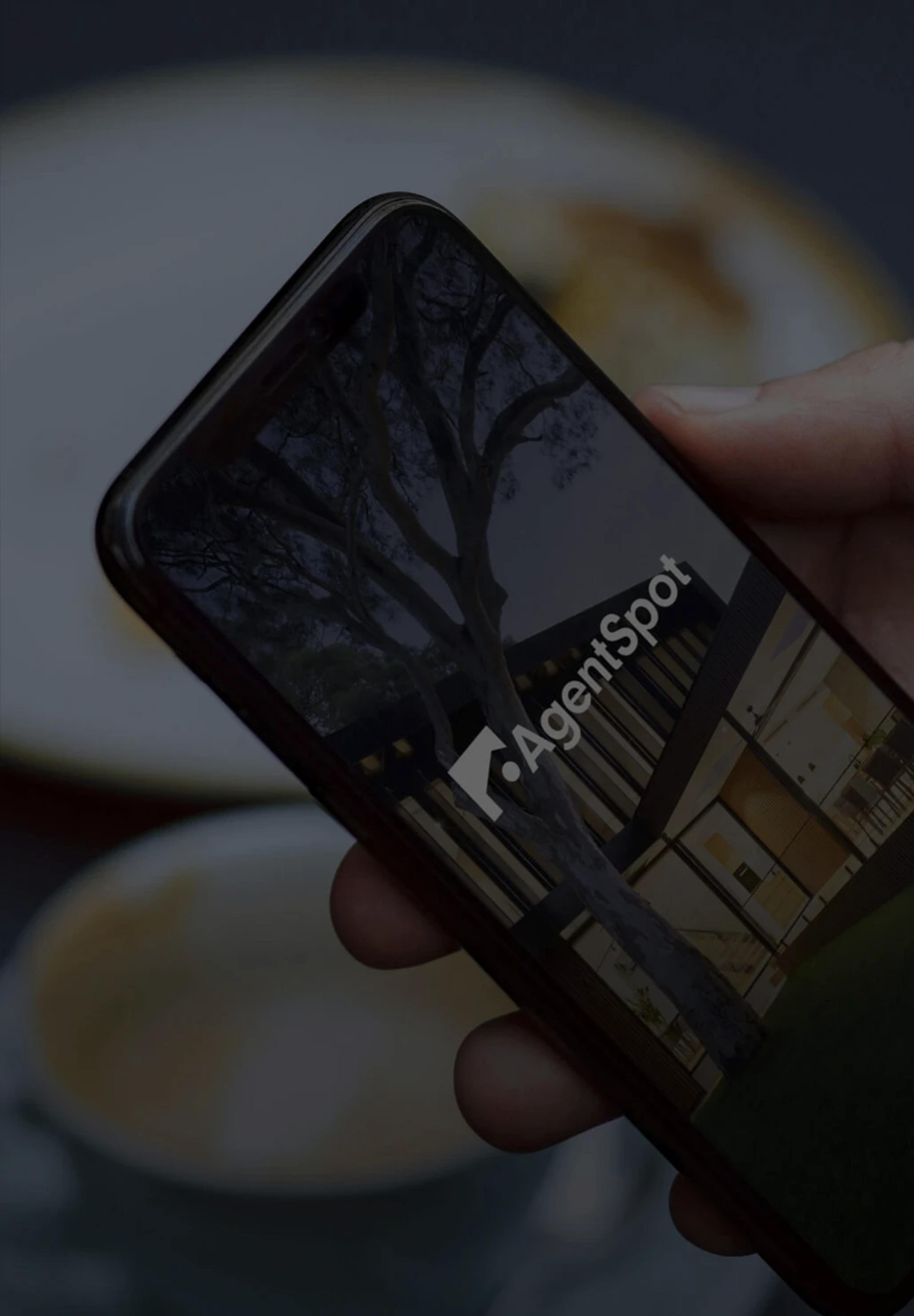 Phone with the agent spot logo displayed on its screen