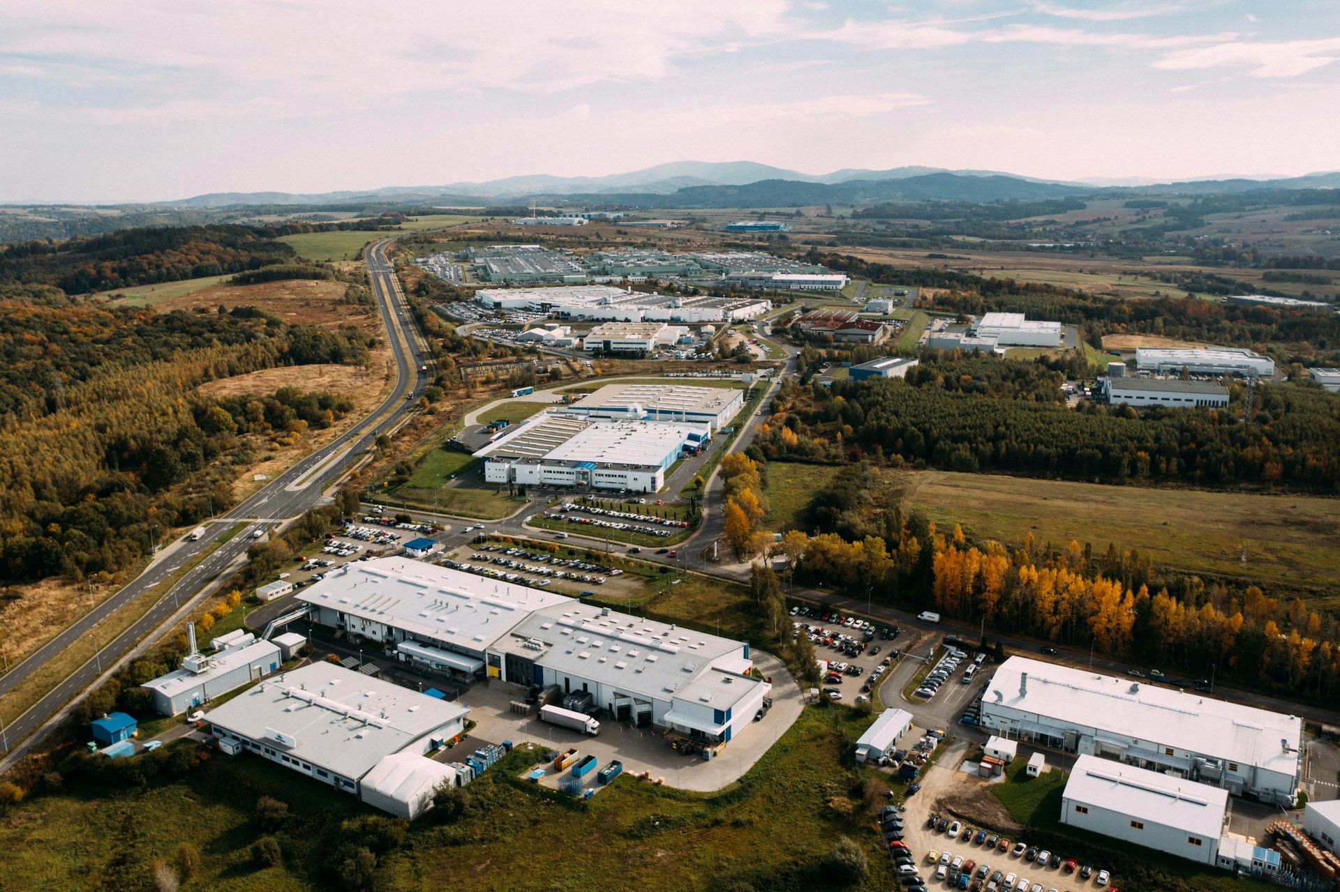 Aerial drone view of an industrial manufacturing complex, representing global contract manufacturing partnerships
