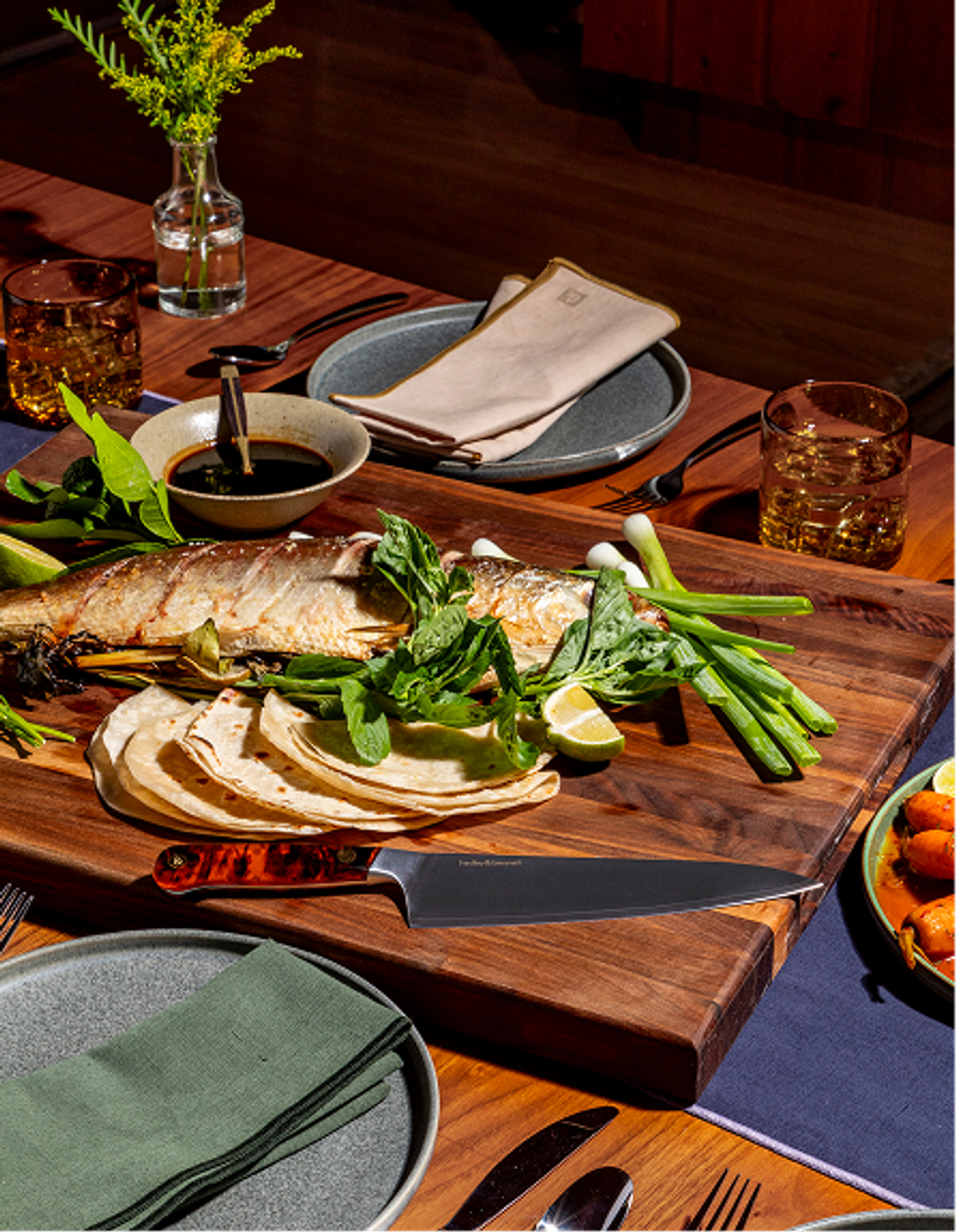 fish dinner with sharp knife on cutting board