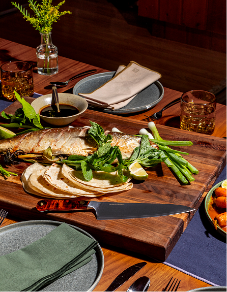 fish dinner with sharp knife on cutting board