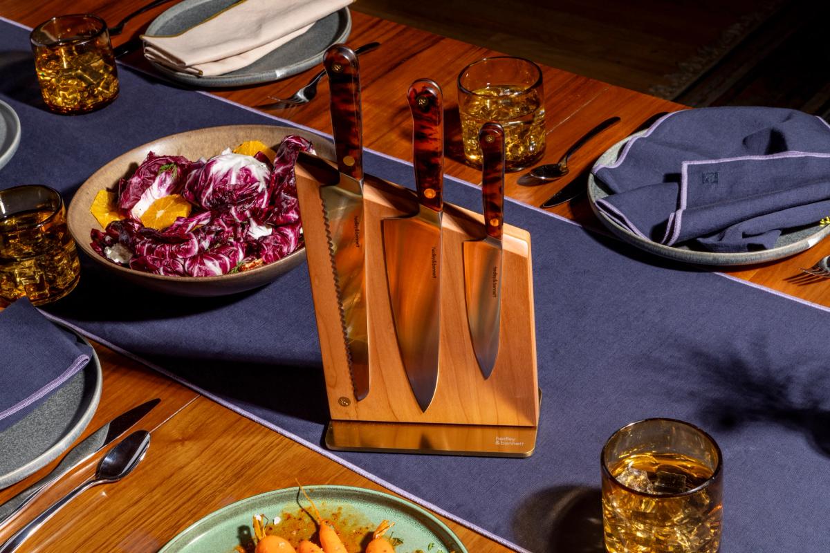 knives in wooden knife holder on set dining table