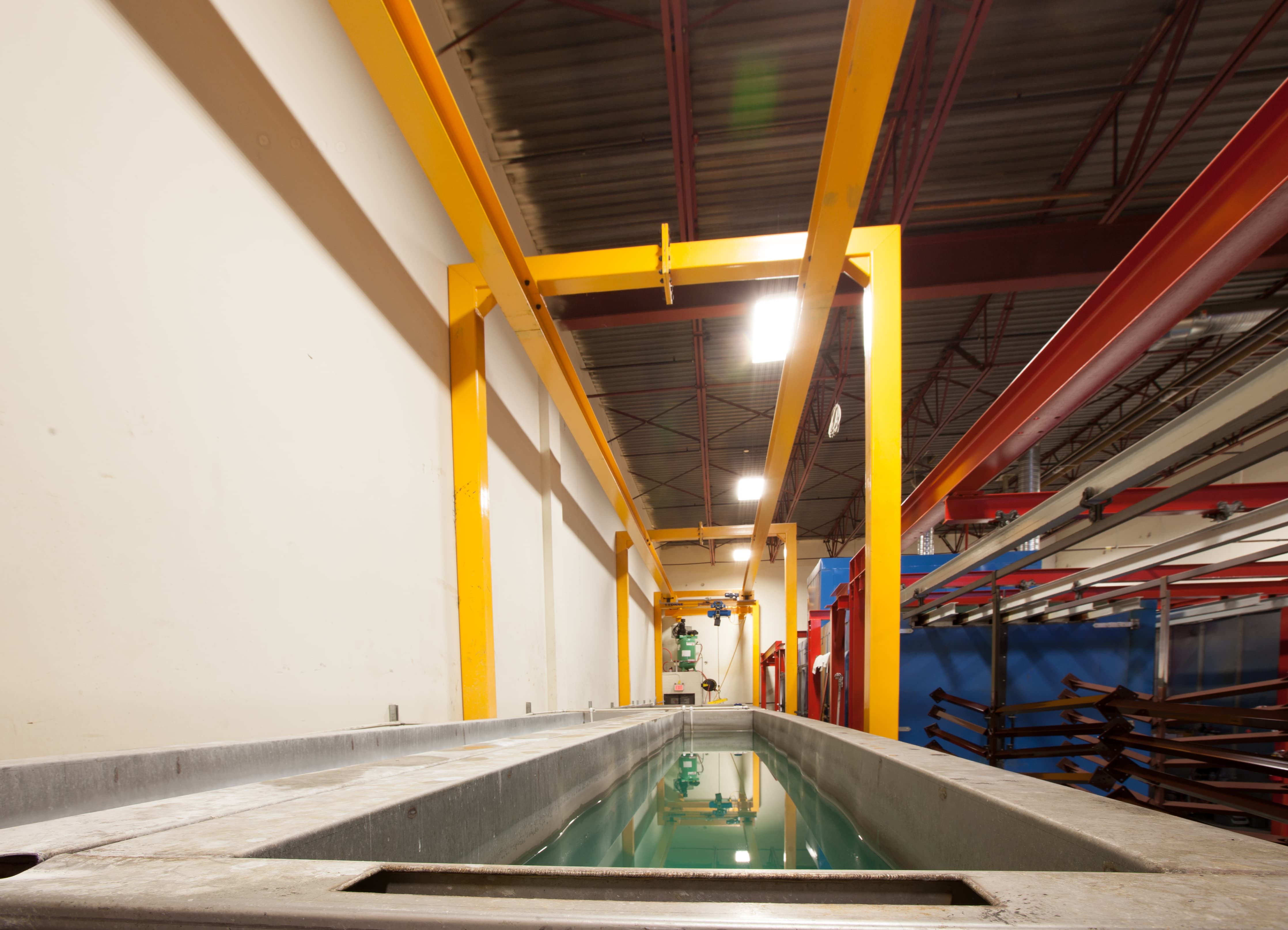 5-stage full submersion pretreatment tank line with overhead crane at Innovative Aluminum's Aldergrove powder coating facility
