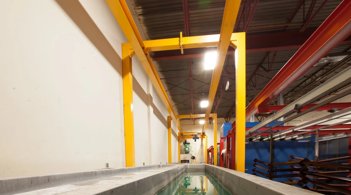 5-stage full submersion pretreatment tank line with overhead crane at Innovative Aluminum's Aldergrove powder coating facility
