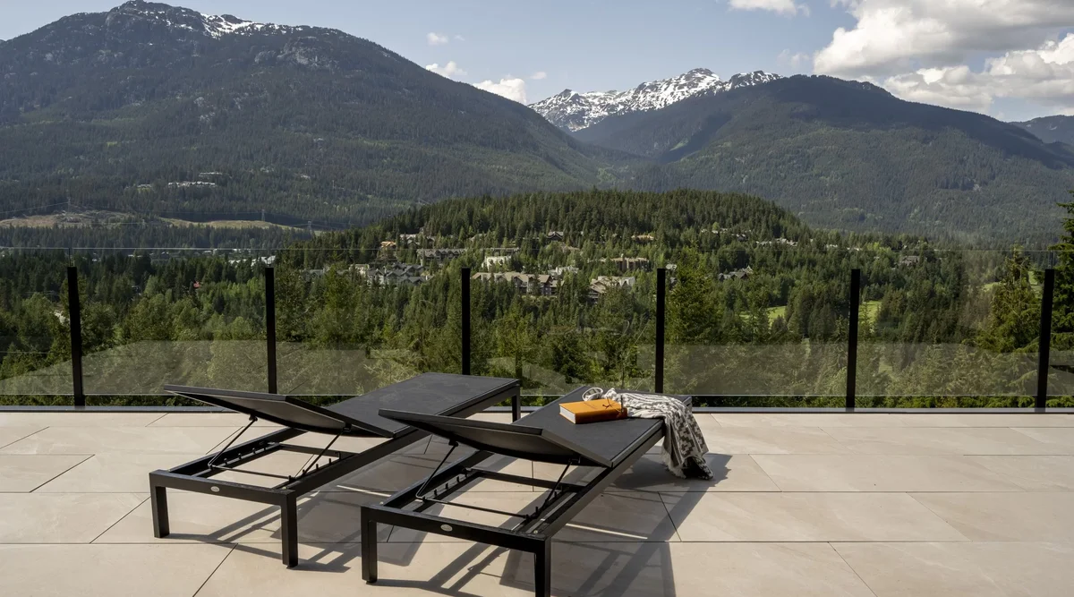 Glass deck railing installed on a modern residential property with panoramic views
