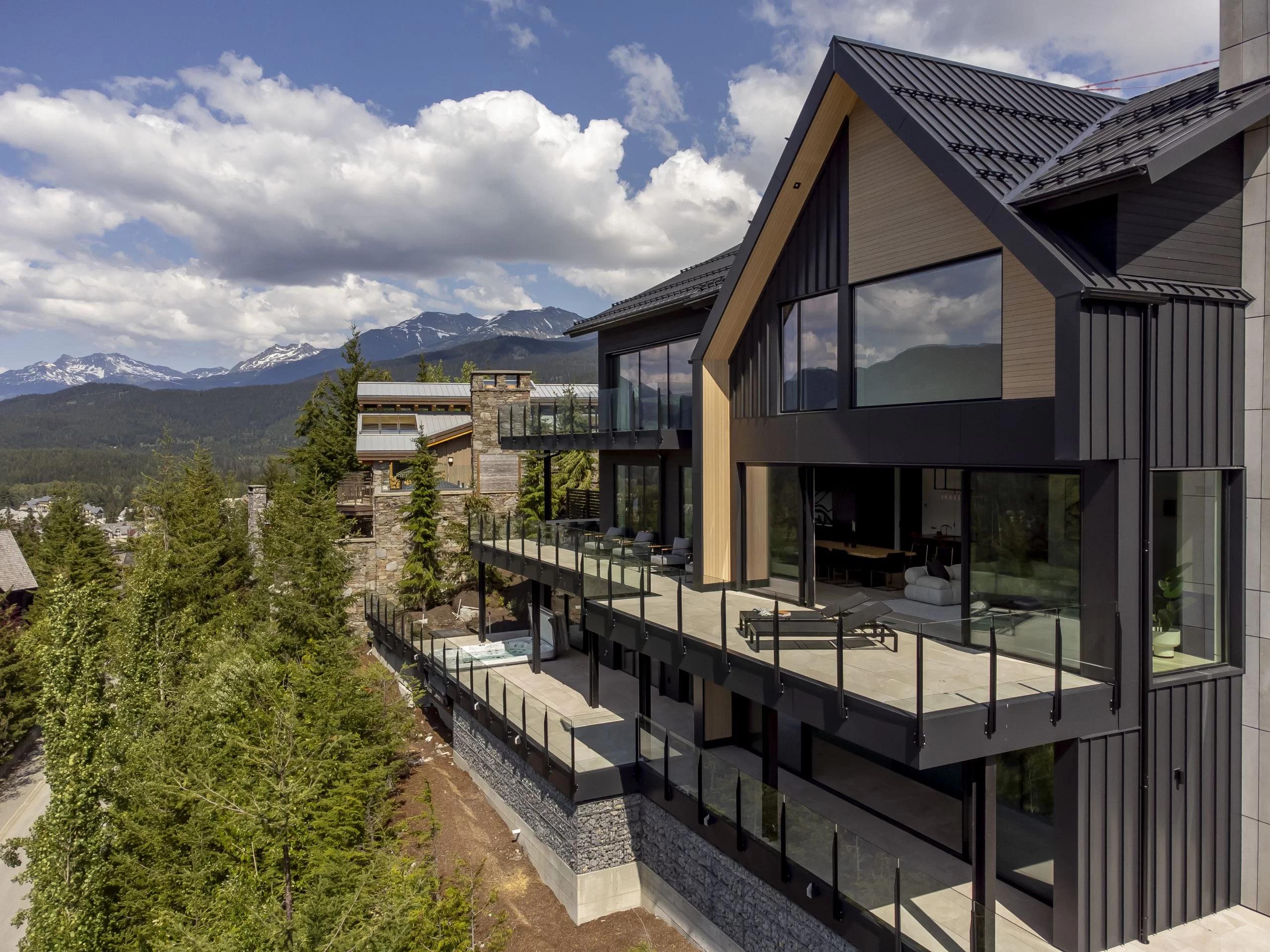 Powder coated aluminum deck railing with glass panels on an elevated residential deck showing mountain views