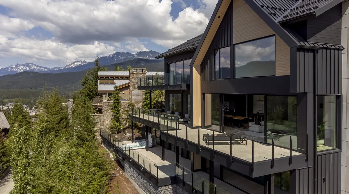 Powder coated aluminum deck railing with glass panels on an elevated residential deck showing mountain views
