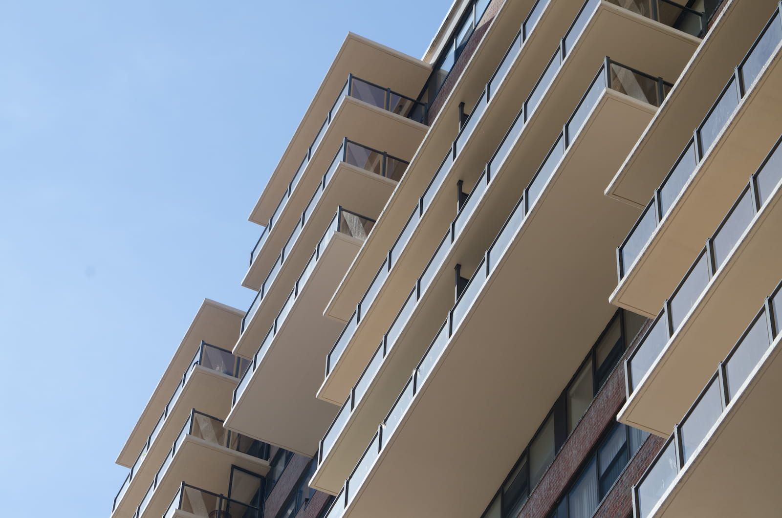 Surface mount glass railing with tinted glass panels on multi-story balconies at the Metropolis towers in Newark New Jersey