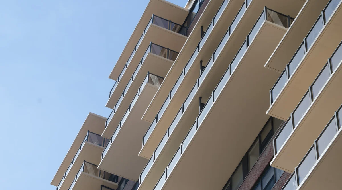Surface mount glass railing with tinted glass panels on multi-story balconies at the Metropolis towers in Newark New Jersey