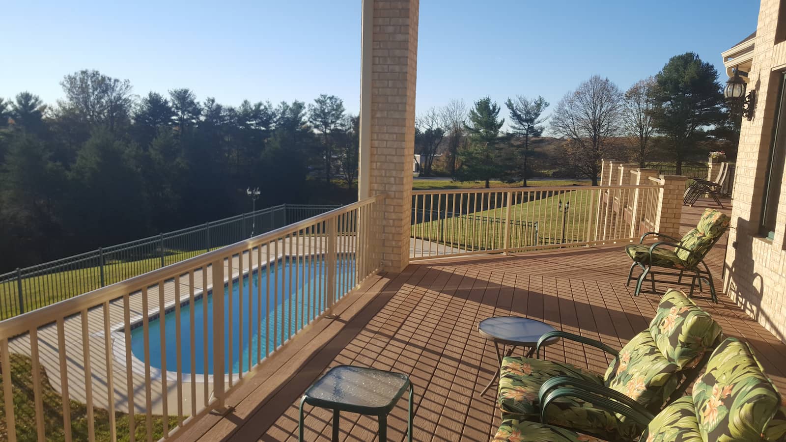 Light ivory powder coated aluminum picket railing around a pool deck in Maryland