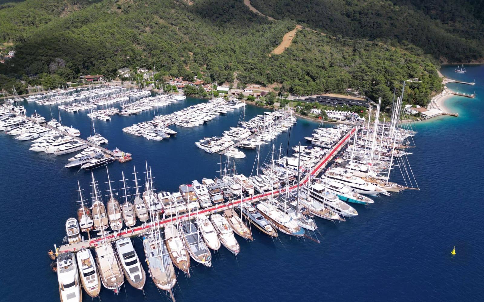 Elegant yacht cruising on calm blue sea under clear sky.