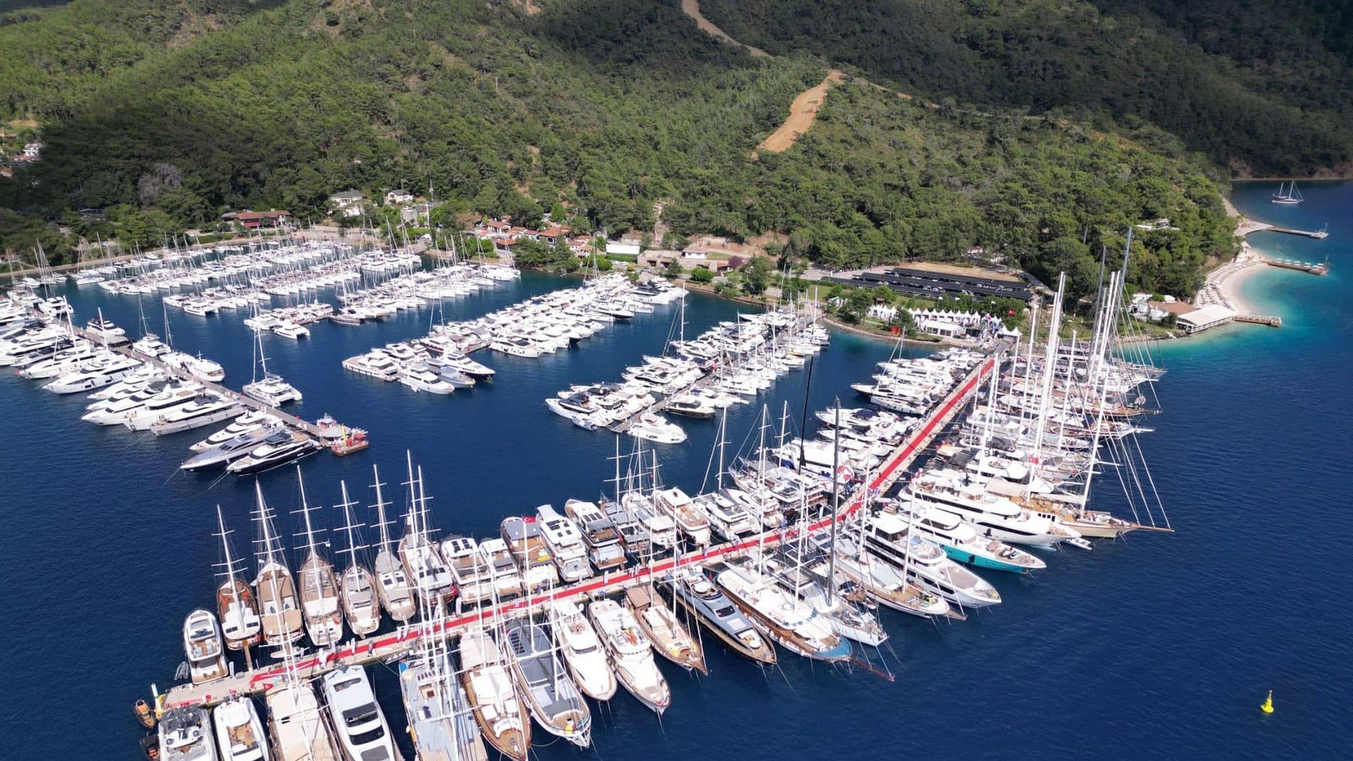 Elegant yacht cruising on calm blue sea under clear sky.