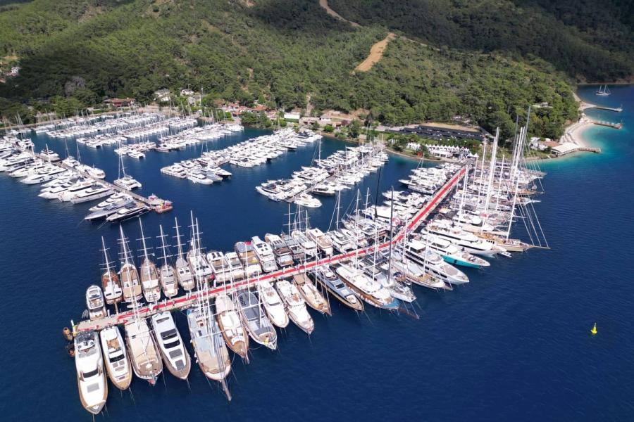 Elegant yacht cruising on calm blue sea under clear sky.