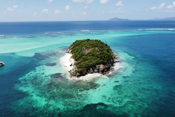 Yacht sailing on calm sea.