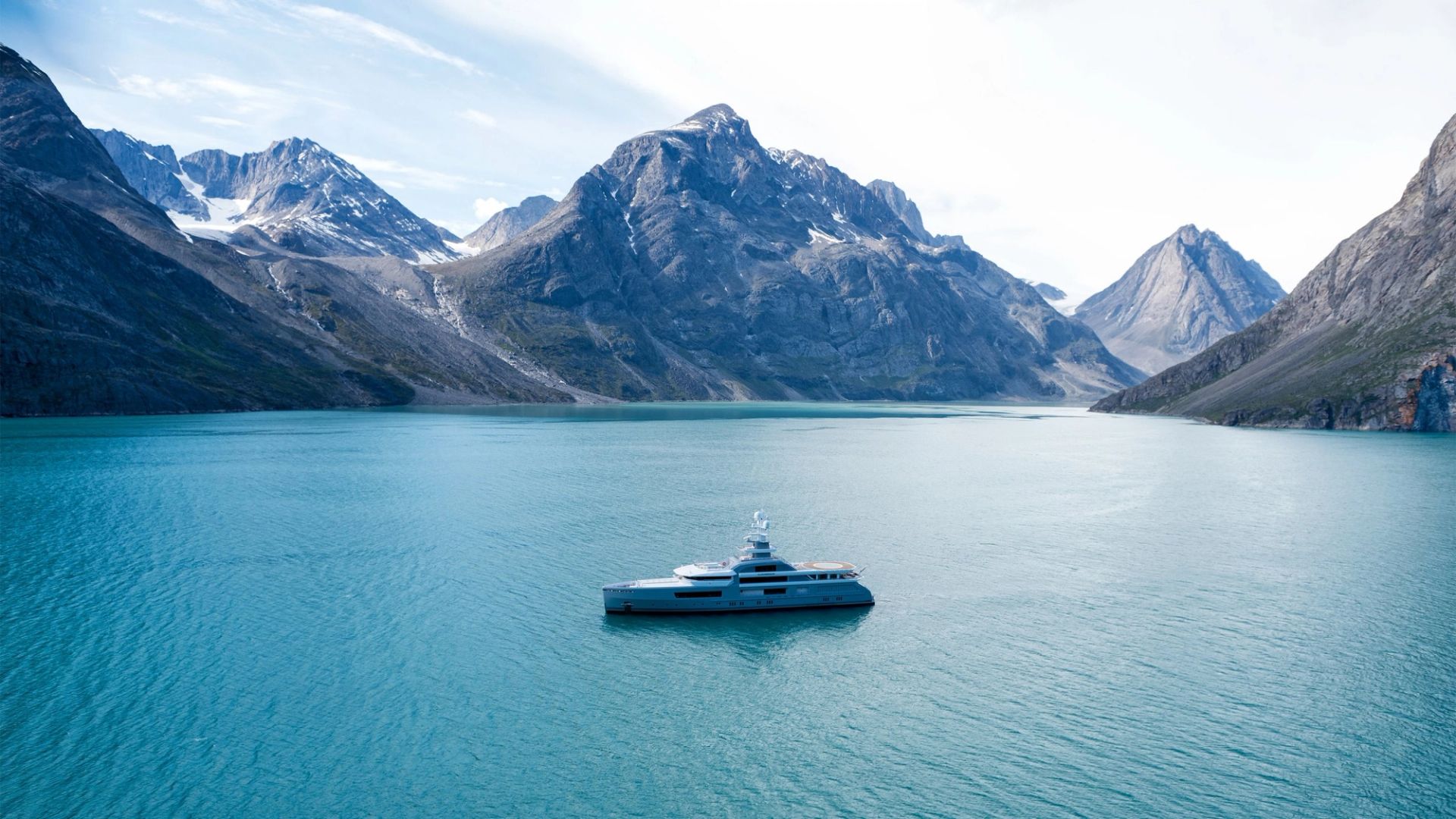 Aerial view of luxury yacht cruising on calm blue waters under clear skies