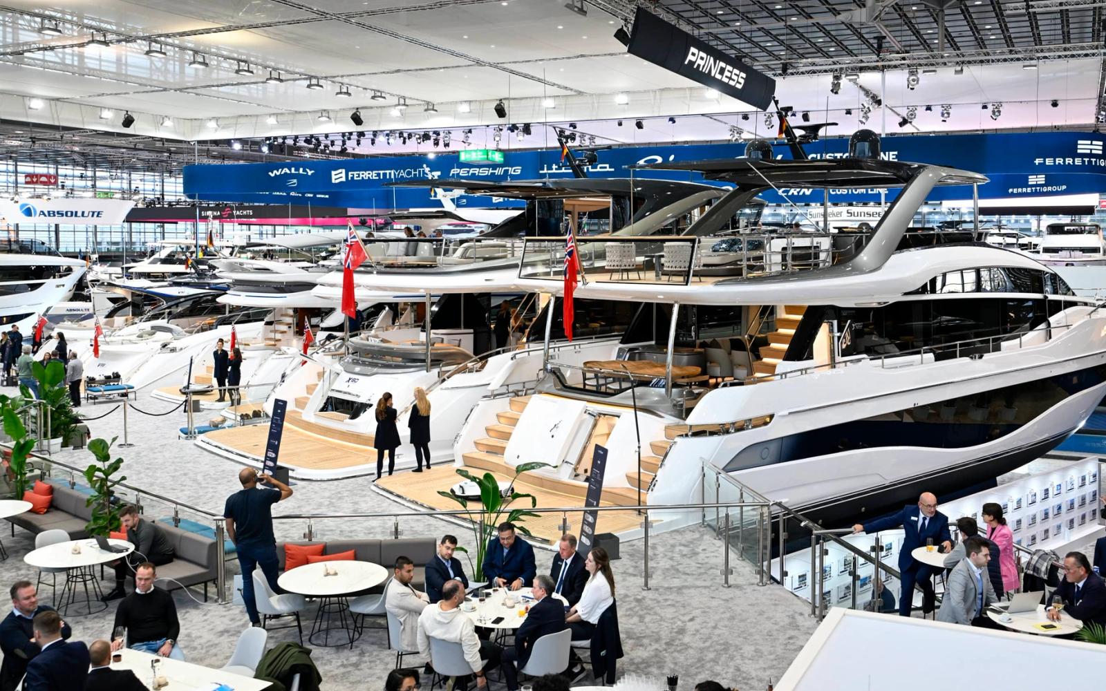 Luxurious yacht docked by the shore with a scenic cityscape in the background.