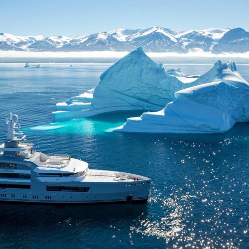Yacht with sails against a clear blue sky.