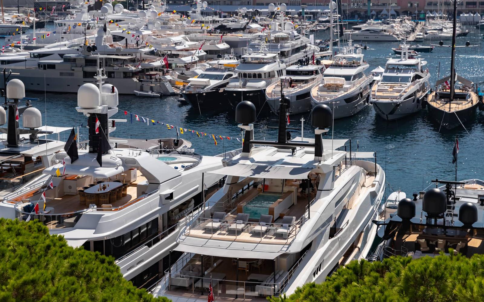 Luxury yacht sailing on calm waters during sunset.
