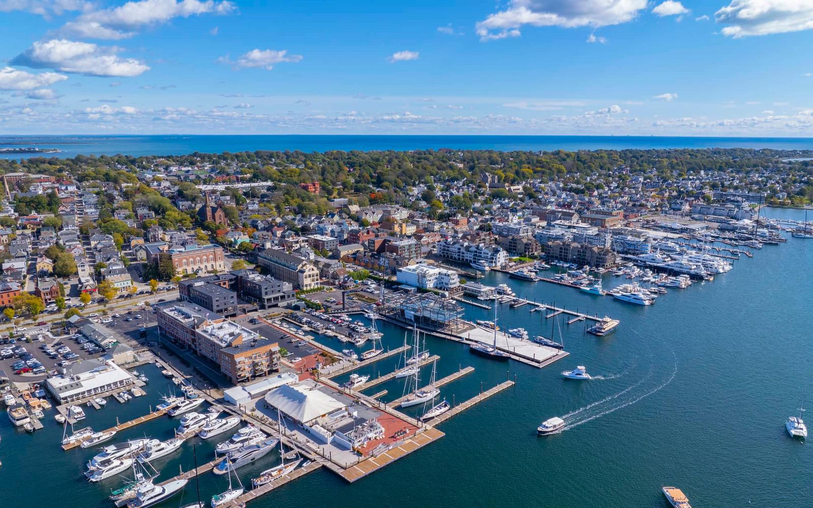 Luxury yacht sailing on calm sea with sunset sky.