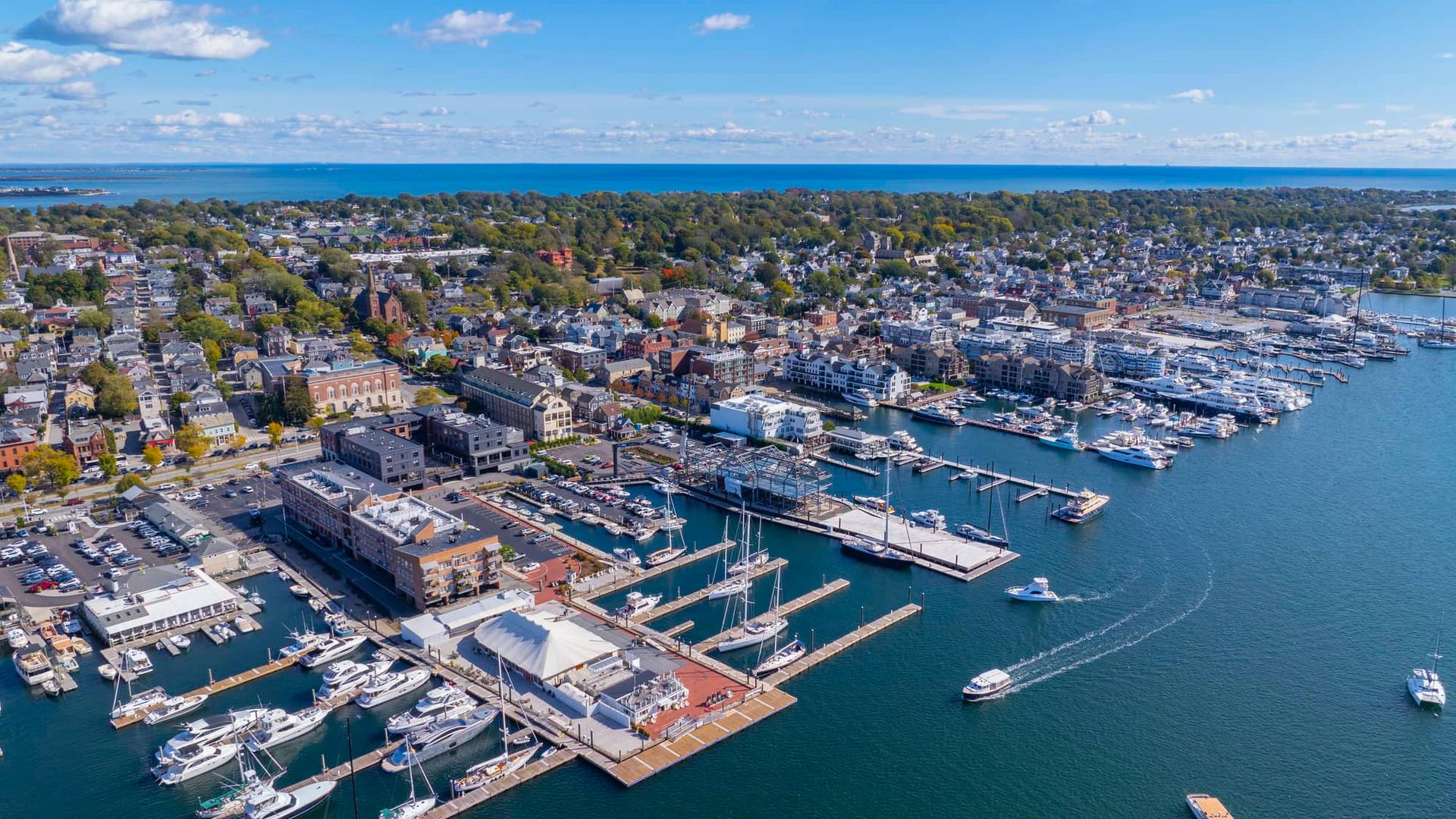Luxury yacht sailing on calm sea with sunset sky.