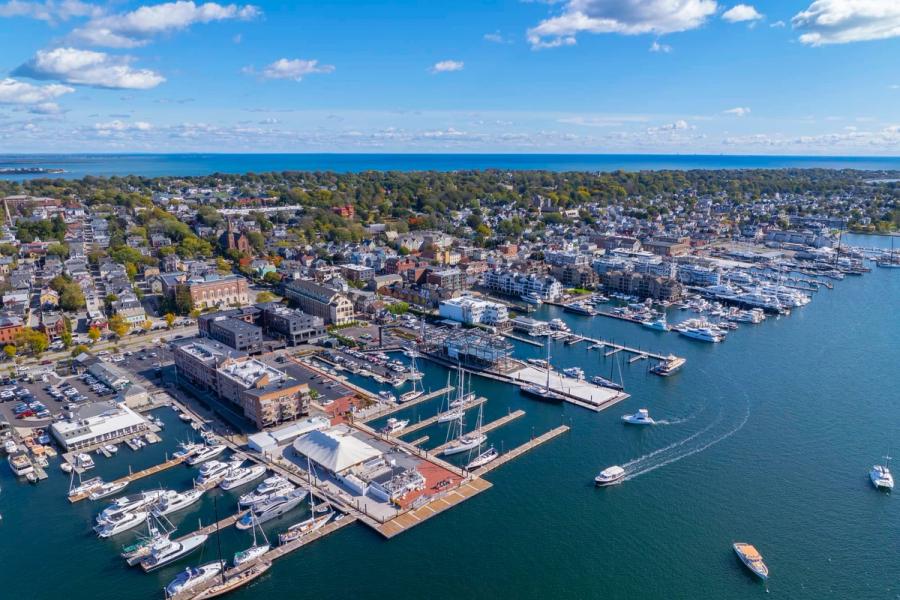 Luxury yacht sailing on calm sea with sunset sky.