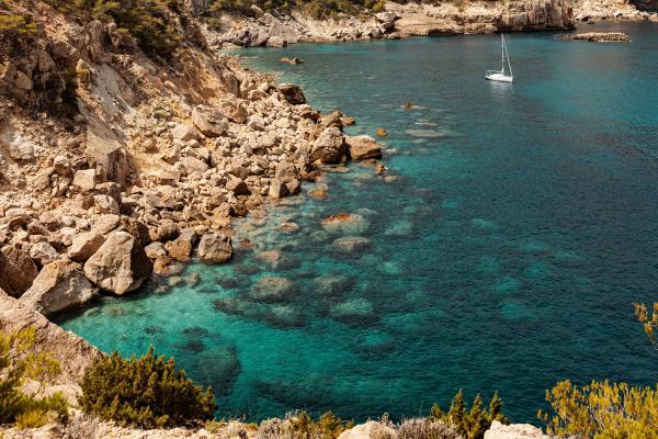 Professional yacht staff member in formal attire ready to welcome guests.