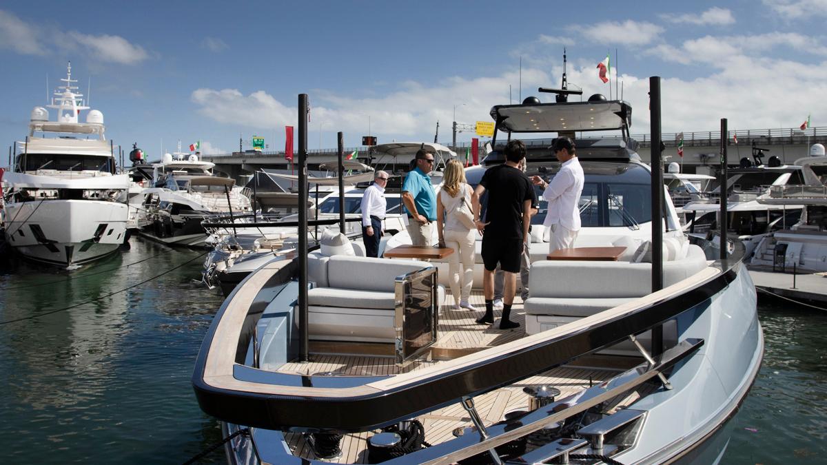 Luxury yacht cruising on calm blue sea under sunny sky.