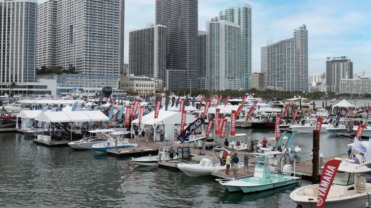 Elegant white yacht docked at marina with clear blue sky.