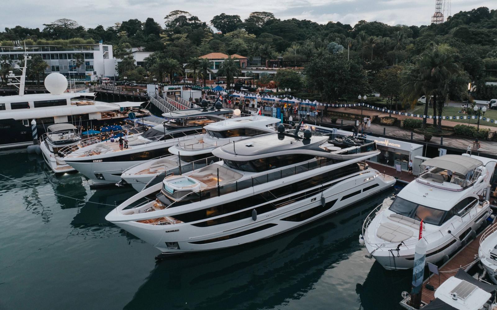 Luxury yacht docked at marina with clear blue sky and calm water