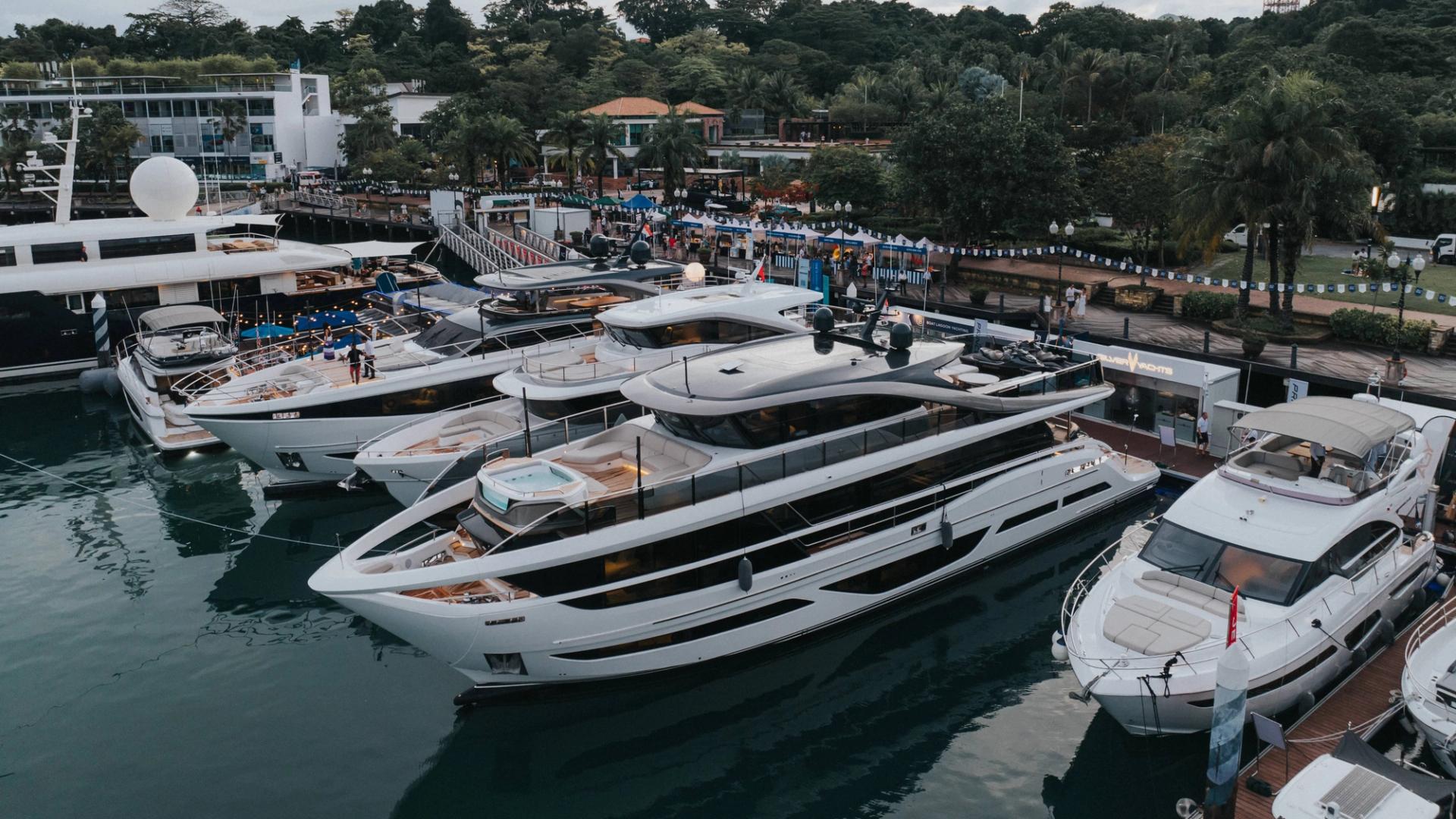 Luxury yacht docked at marina with clear blue sky and calm water