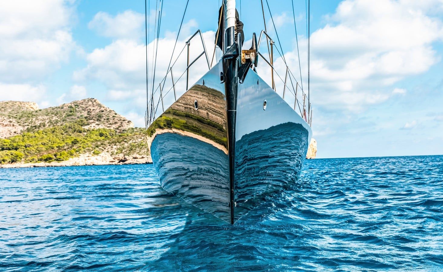 Elegant white luxury yacht docked at marina with clear blue water and sunny sky, ready for sailing.”