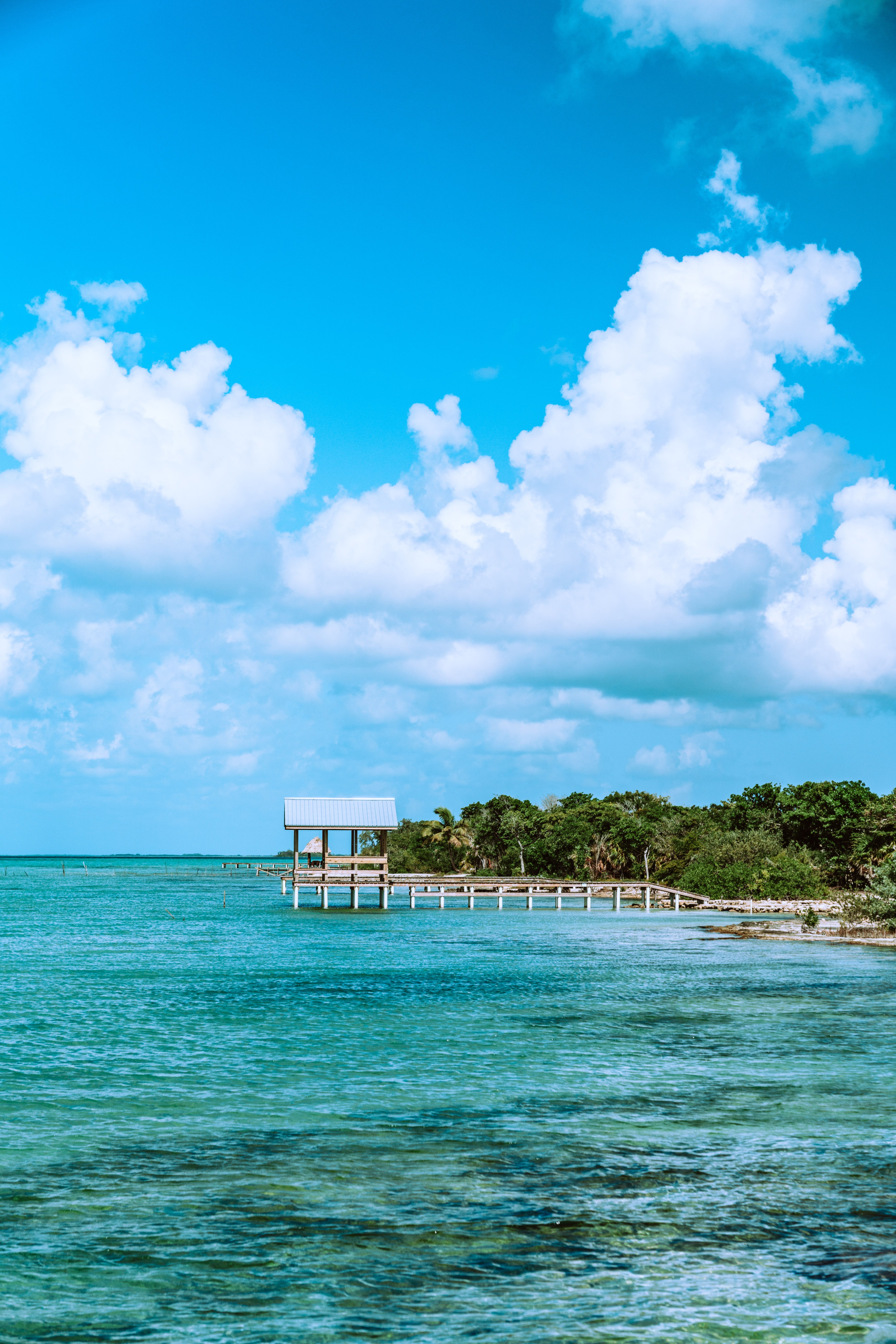 Expansive view of a superyacht positioned in a tranquil blue bay.
