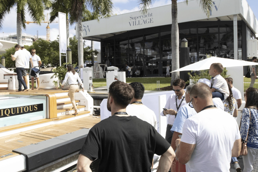 Modern yacht cruising on calm blue sea under a clear sky.