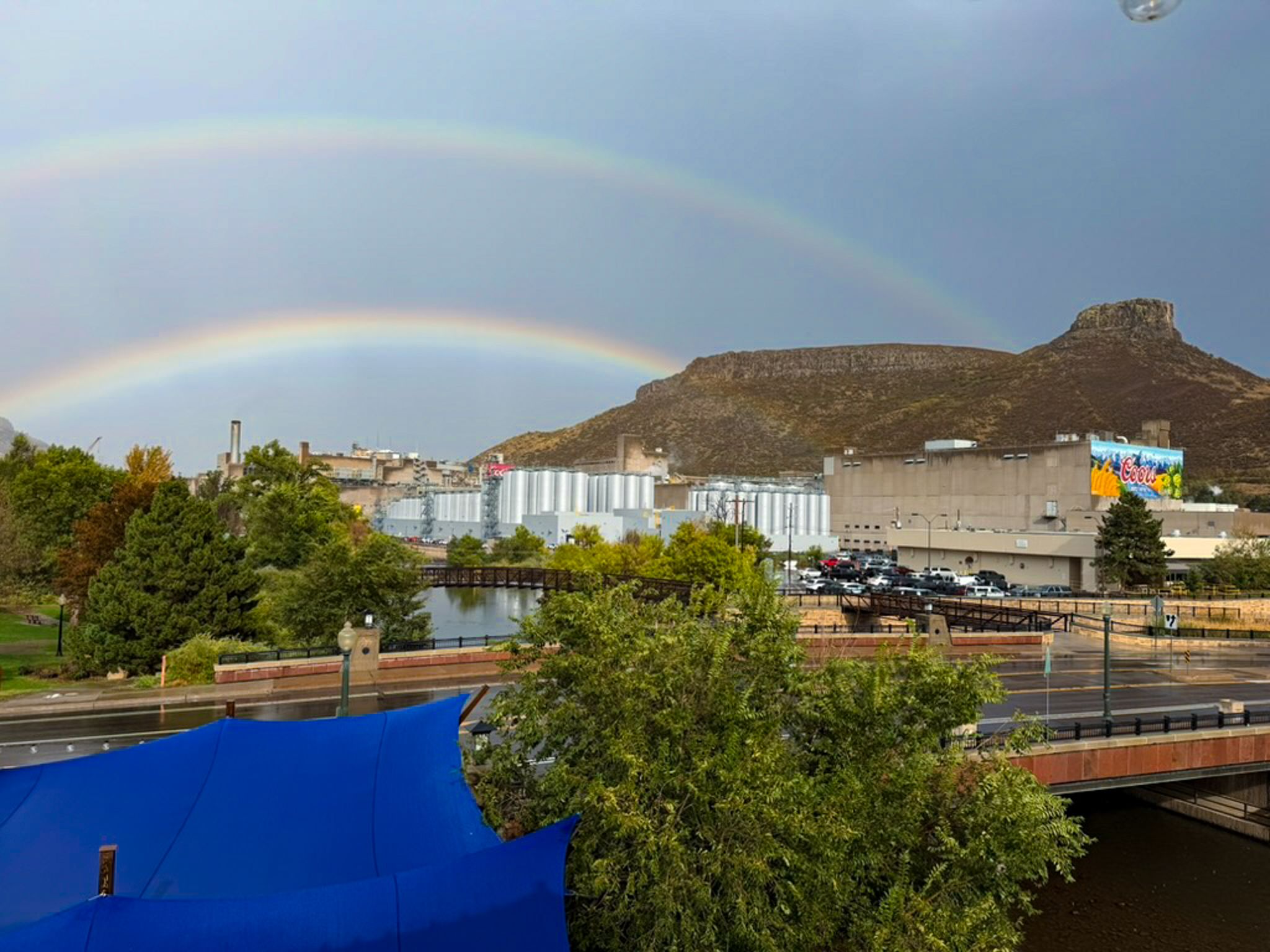Looking out over Coors brewery with a double rainbow along South Table Mountain