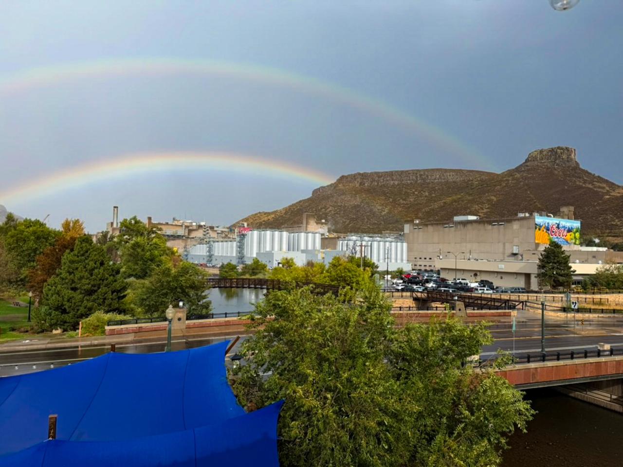Looking out over Coors brewery with a double rainbow along South Table Mountain