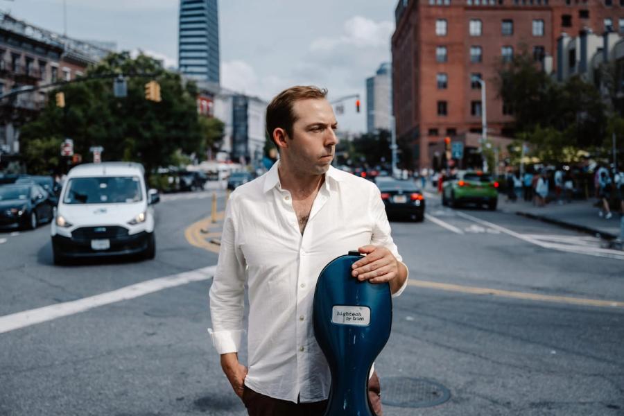 Brook Speltz on a NYC street with cello case